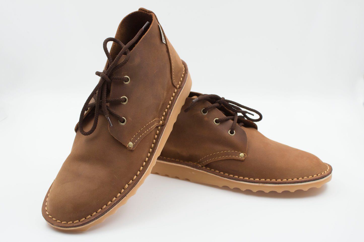 Handmade high-cut veldskoen in medium brown full-grain leather with brass eyelets and crepe sole