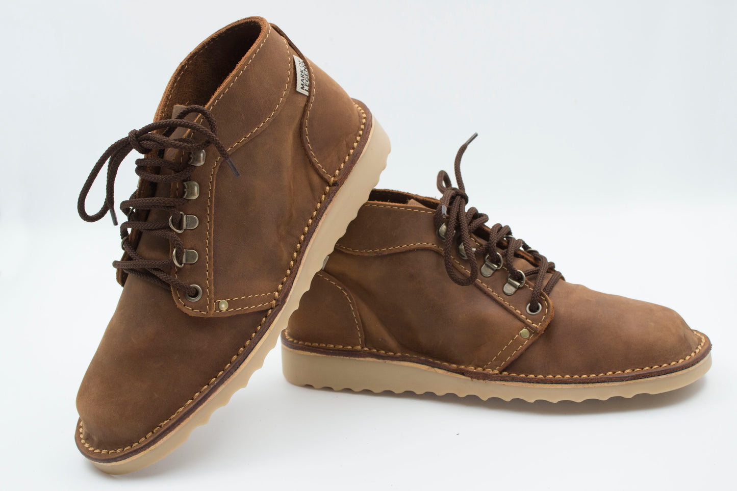 Medium brown Ranger boot pair showing full-grain leather texture and hiking-style lacing with crepe sole