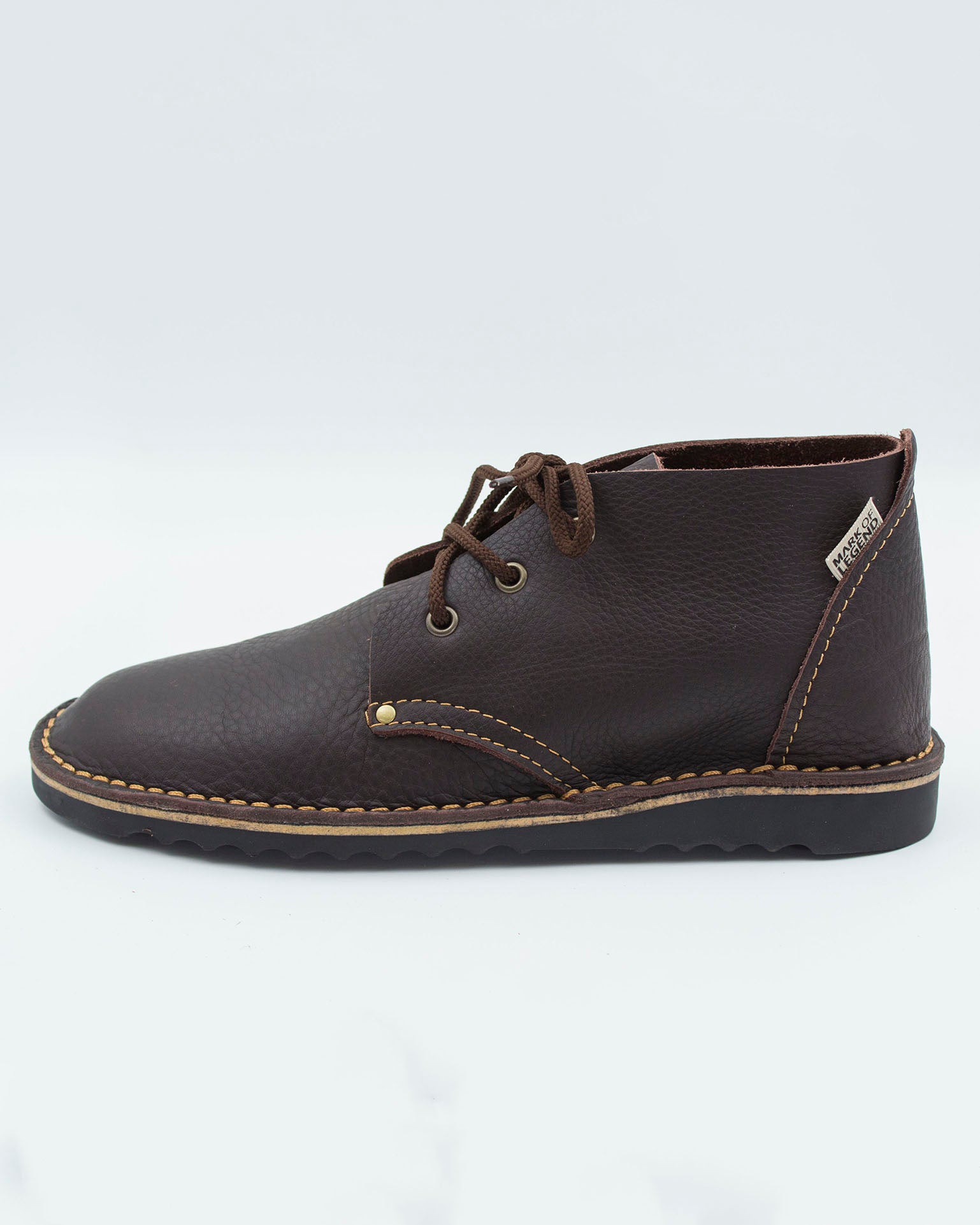 Side view of South African high-cut veldskoen in dark brown leather showing ankle height and sole