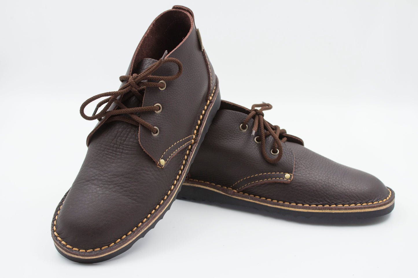 Handmade high-cut veldskoen in dark brown full-grain leather with brass eyelets and black sole