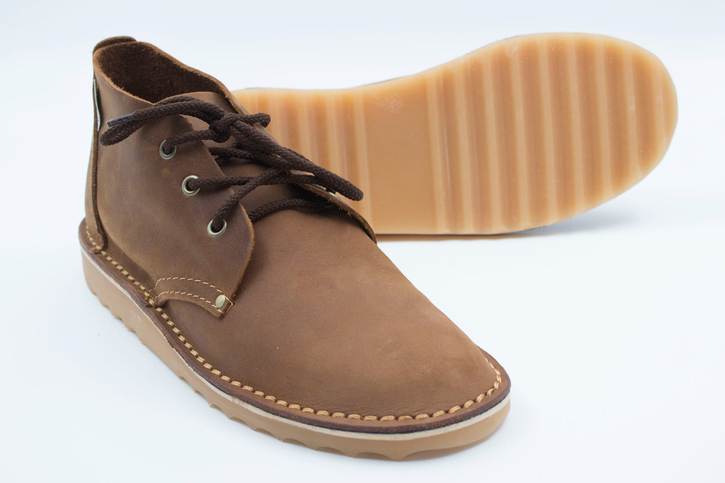 High-cut veldskoen medium brown leather with durable ridged crepe sole showing traction pattern
