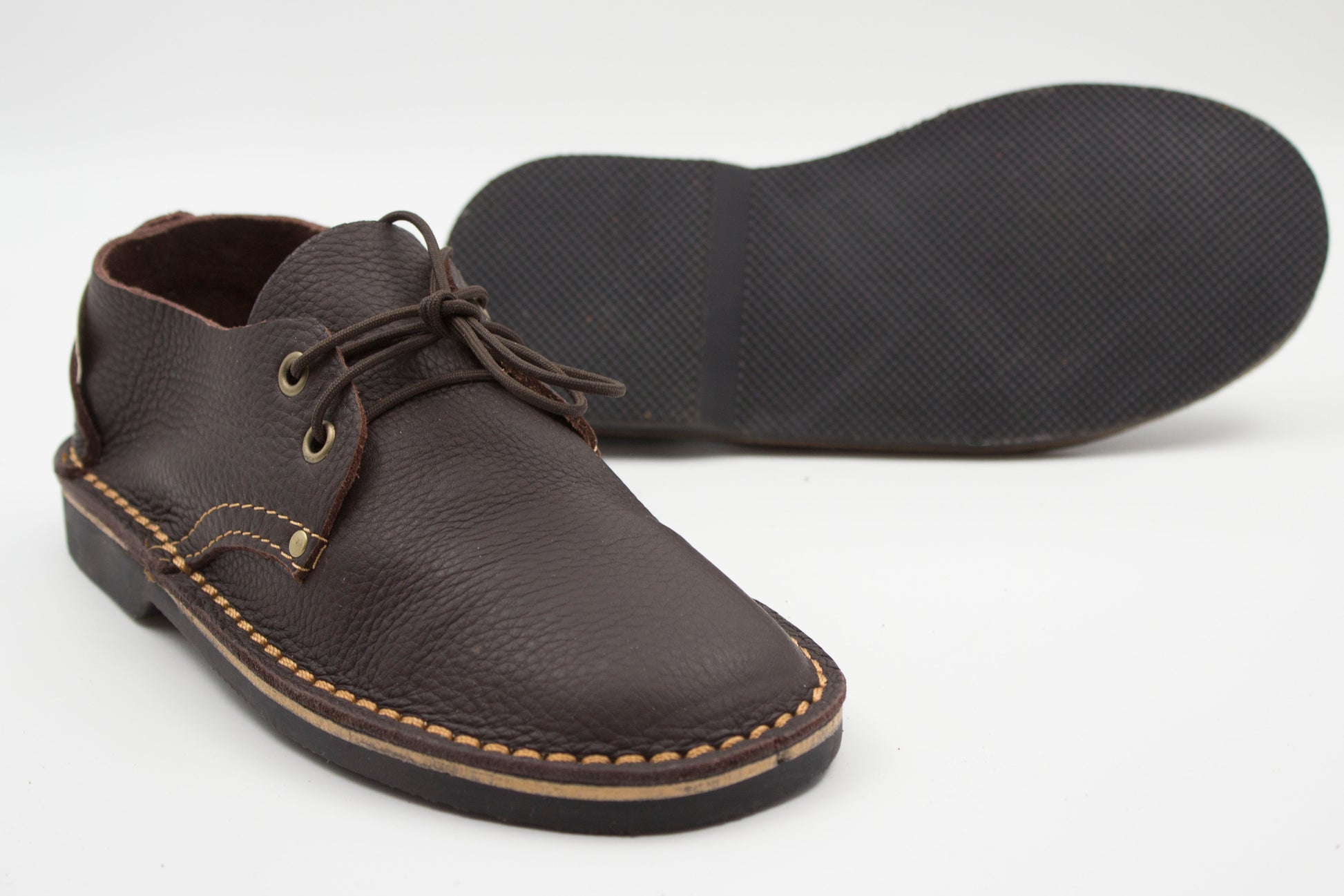 Ladies veldskoen dark brown leather with durable Pyramid black sole showing textured grip pattern
