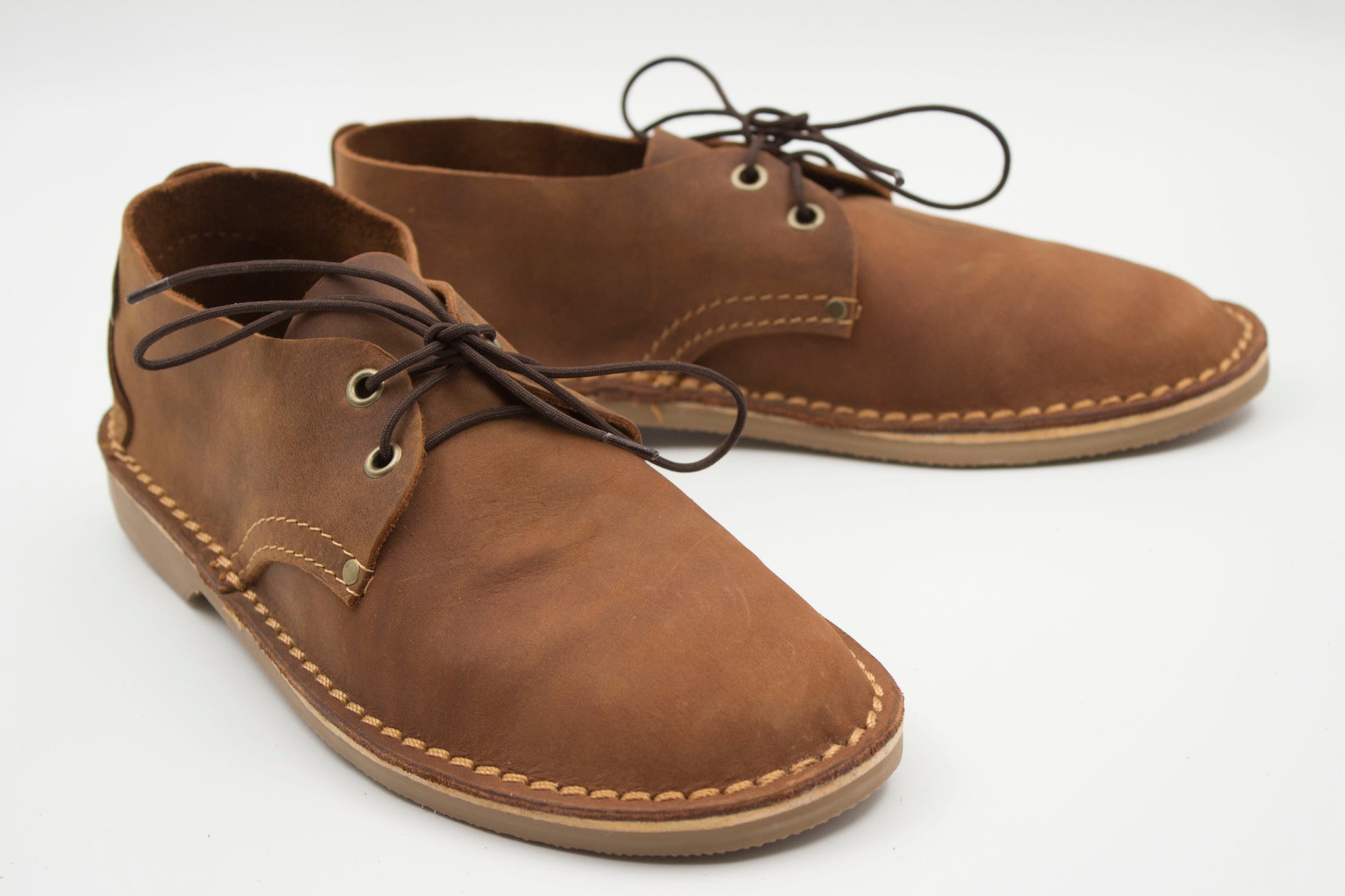 Handmade ladies veldskoen in medium brown full-grain leather with brass eyelets and machine-stitched sole