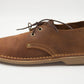Side view of South African handmade vellie in medium brown leather showing traditional stitching detail