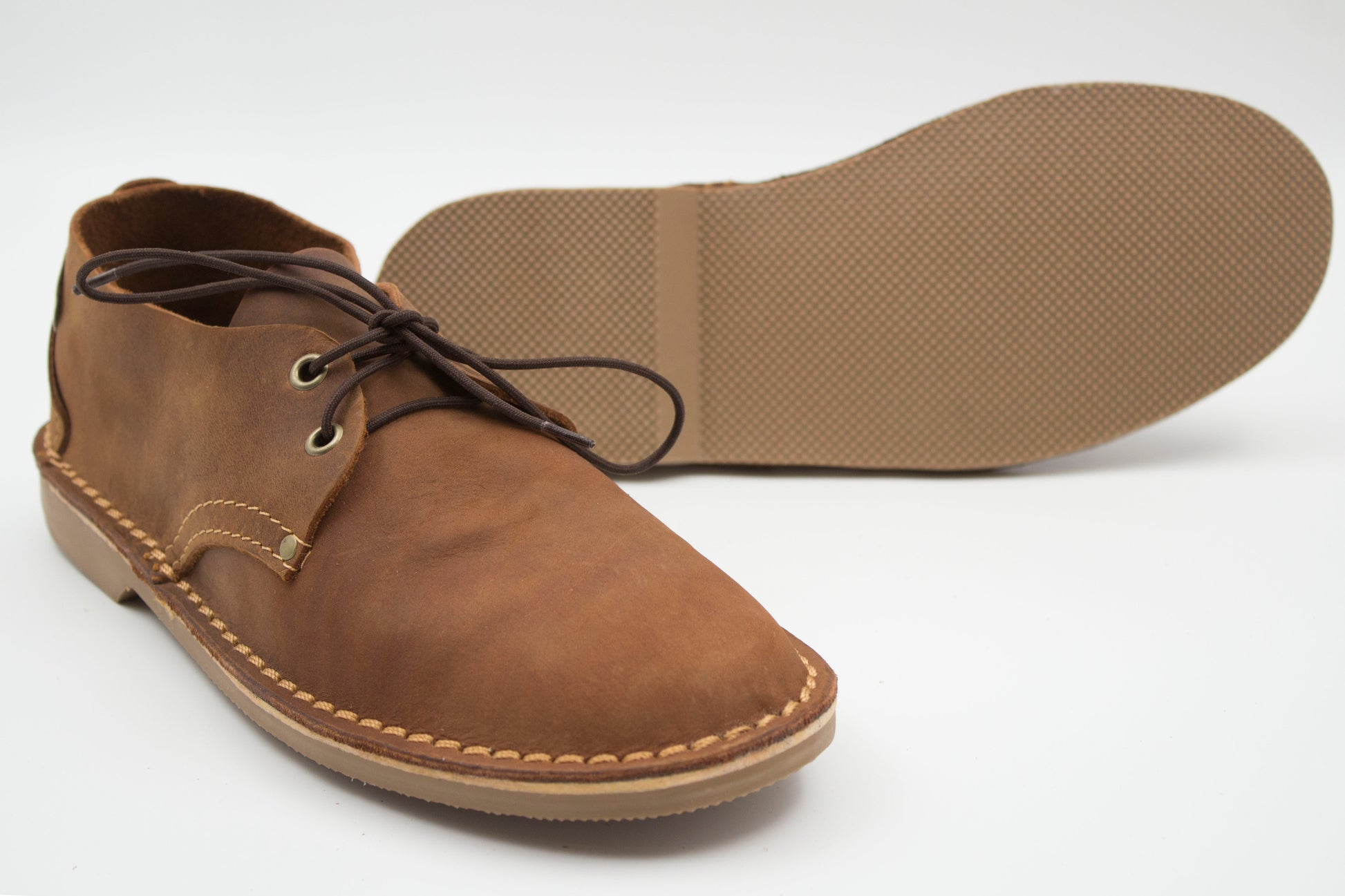 Ladies veldskoen medium brown leather with durable Pyramid Muddy Brown sole showing textured grip pattern
