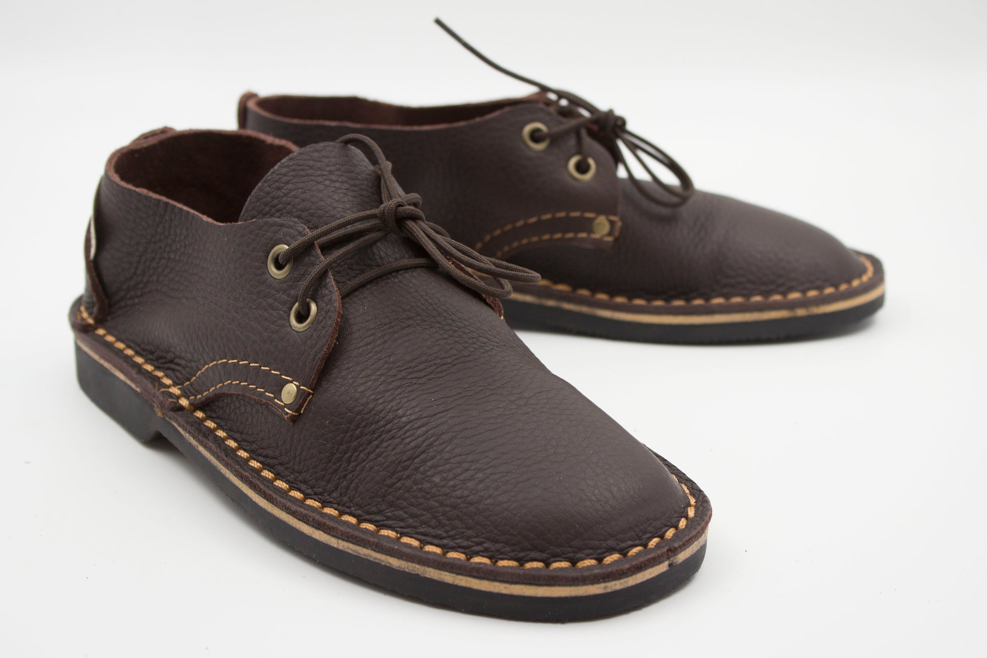Handmade ladies veldskoen in dark brown full-grain leather with brass eyelets and machine-stitched sole