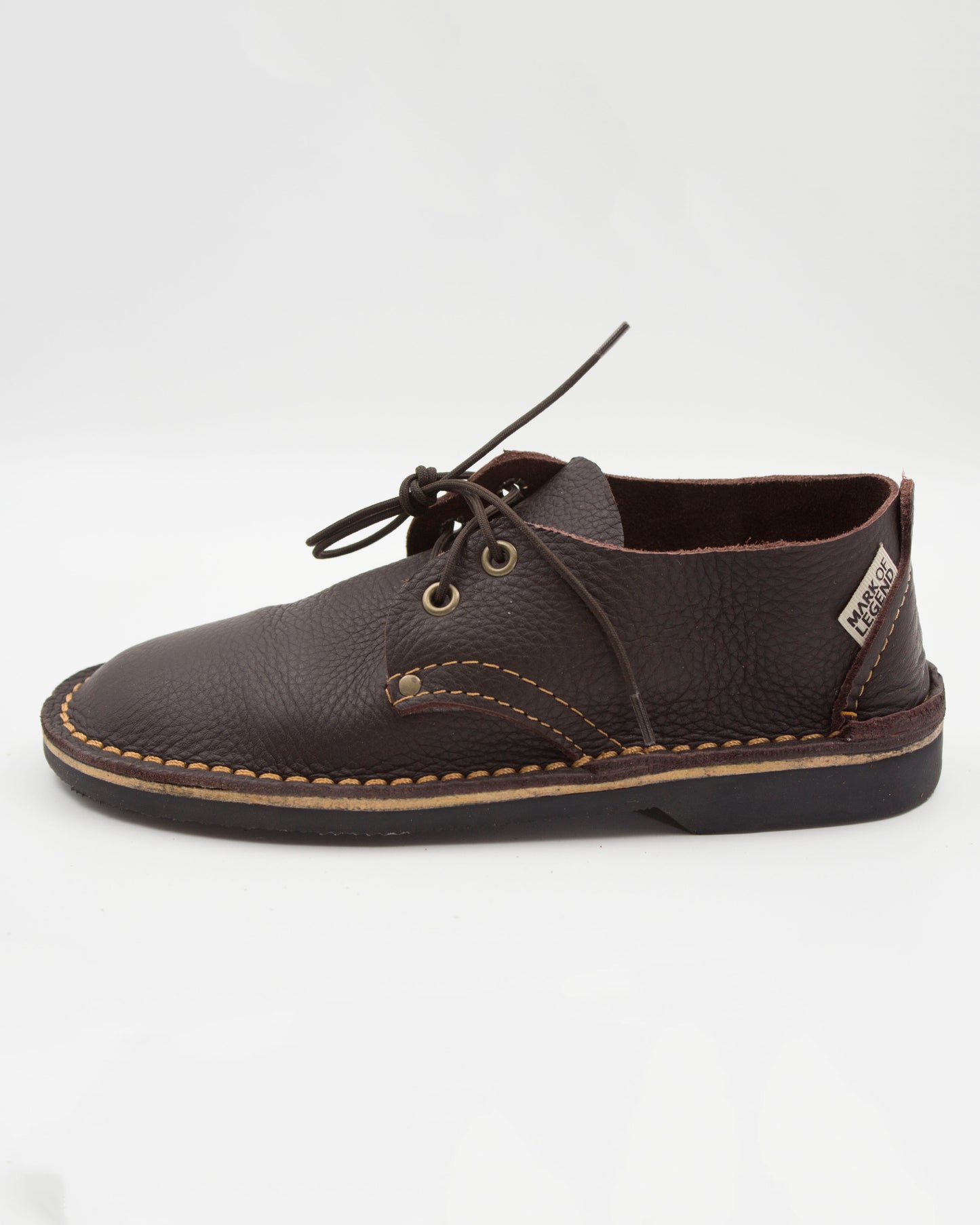 Side view of South African handmade vellie in dark brown leather showing traditional stitching detail